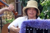 Jo, with hat and decorated music stand at a 2006 garden party