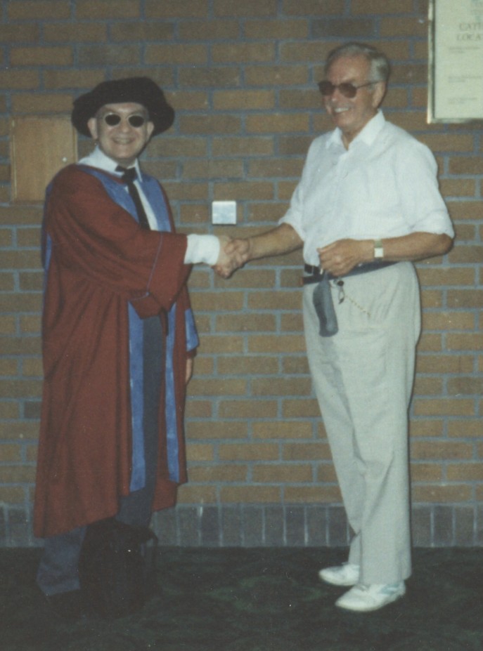 Dave in fancy dress! Just after his PhD award ceremony, shaking hands with his late Dad
