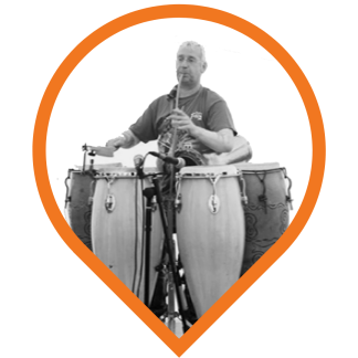 Paul Midgley, surrounded by drums. The way he likes it. And what's that in his mouth? Could it be a 'junk flute'?