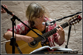 Jo smiles as she plays her guitar. FiddleBop at the Foundry, 23 April 2025. Photo: <a href="https://www.facebook.com/BreconAreaLiveMusicPhotos" target="_blank" rel="noopener">Barry Hill</a>