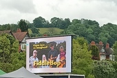 FiddleBop on a large screen at the Brecon Jazz Festival Warm-Up on 13 June 2024