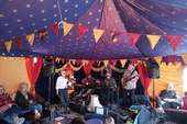 FiddleBop in the Blue Moon tent at HowTheLightGetsIn Festival, Hay-on-Wye, 26 May 2024. Bill the soundman looks attentively on