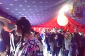 Some of the audience look out at the torrential rain: FiddleBop in the Blue Moon tent at HowTheLightGetsIn Festival, Hay-on-Wye, 26 May 2024