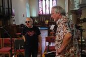 Dave and Graeme discuss setting up our equipment in St Mary's: FiddleBop at Brecon Jazz festival, August 2023